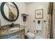 Charming bathroom with ornate mirror, granite countertop and decorative tile accents at 9233 Silver Lake Dr, Leesburg, FL 34788