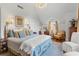 Bedroom with crystal chandelier, neutral colored walls, and hardwood floors at 9233 Silver Lake Dr, Leesburg, FL 34788