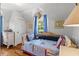 Nautical-themed bedroom with a trundle bed, natural light, and hardwood floors at 9233 Silver Lake Dr, Leesburg, FL 34788