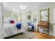 Bright bedroom with a patterned chair, wood floors, and ample natural light at 9233 Silver Lake Dr, Leesburg, FL 34788