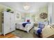 Serene bedroom with soft green walls, wood floors, and natural light at 9233 Silver Lake Dr, Leesburg, FL 34788