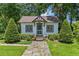 Charming cottage home with stone pathway, complemented by meticulously maintained landscaping at 9233 Silver Lake Dr, Leesburg, FL 34788