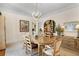 Elegant dining room with a chandelier, hardwood floors, and a dining table with seating for six at 9233 Silver Lake Dr, Leesburg, FL 34788