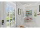 Bright dining area with shuttered windows, a quaint table, and unique plate display at 9233 Silver Lake Dr, Leesburg, FL 34788