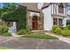 Close-up of the stone-accented entrance with lush greenery and a charming gate at 9233 Silver Lake Dr, Leesburg, FL 34788