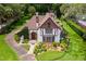 Charming Tudor-style home with manicured lawn, stone accents, and a classic fountain feature at 9233 Silver Lake Dr, Leesburg, FL 34788