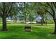Scenic exterior view with a bench overlooking the lake, perfect for relaxation and enjoying the natural surroundings at 9233 Silver Lake Dr, Leesburg, FL 34788