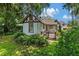 Quaint exterior view of the home, highlighting its charming architecture and lush landscaping at 9233 Silver Lake Dr, Leesburg, FL 34788