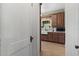 Cozy kitchen featuring wooden cabinetry, farmhouse sink, and sunlit window at 9233 Silver Lake Dr, Leesburg, FL 34788