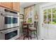 Kitchen breakfast nook by window with stainless oven and light wood cabinets at 9233 Silver Lake Dr, Leesburg, FL 34788