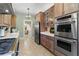 Open kitchen design with stainless steel appliances and view into other rooms at 9233 Silver Lake Dr, Leesburg, FL 34788