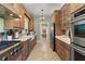 Spacious kitchen with stainless steel appliances, white countertop, and wooden cabinets at 9233 Silver Lake Dr, Leesburg, FL 34788