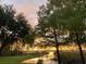 Breathtaking lake view at sunset, with lush greenery framing the tranquil waters, creating a serene landscape at 9233 Silver Lake Dr, Leesburg, FL 34788