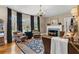 Inviting living room with a decorative fireplace, large windows, hardwood floors, and classic furnishings at 9233 Silver Lake Dr, Leesburg, FL 34788
