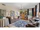 Spacious living room with a comfortable sofa, hardwood floors, a bookcase, and elegant decor at 9233 Silver Lake Dr, Leesburg, FL 34788