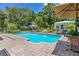 Beautiful outdoor pool area with brick surround and lounge chairs, perfect for relaxation and entertaining at 9233 Silver Lake Dr, Leesburg, FL 34788