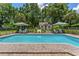Swimming pool and lounge area, framed by lush greenery and privacy fencing at 9233 Silver Lake Dr, Leesburg, FL 34788