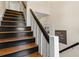 Staircase featuring newly renovated wooden steps painted in black, with a white railing at 9233 Silver Lake Dr, Leesburg, FL 34788