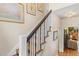 Staircase with light-colored walls adorned with artwork, adjacent to a living room at 9233 Silver Lake Dr, Leesburg, FL 34788