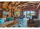 Inviting sunroom featuring wood paneled walls, vaulted ceilings, water views and bright geometric-patterned floor covering at 9233 Silver Lake Dr, Leesburg, FL 34788
