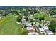 Scenic aerial view showcasing homes nestled amidst lush greenery, golf courses, and a tranquil lake, a beautiful community at 926 Saint Andrews Blvd, Lady Lake, FL 32159