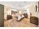 A traditionally styled bedroom featuring neutral colors, lamps, and coordinating furniture at 926 Saint Andrews Blvd, Lady Lake, FL 32159