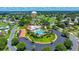An overhead shot capturing a pool surrounded by lush landscaping, palm trees and an inviting outdoor seating area at 926 Saint Andrews Blvd, Lady Lake, FL 32159