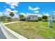 Charming single-story home with lush green lawn and beautiful landscaping at 926 Saint Andrews Blvd, Lady Lake, FL 32159