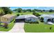 Charming single-story home with an inviting driveway, screened-in carport, and well-maintained lawn at 926 Saint Andrews Blvd, Lady Lake, FL 32159