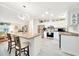 Well-lit kitchen showcasing a central island, modern light fixture, and stainless steel appliances, perfect for culinary enthusiasts at 926 Saint Andrews Blvd, Lady Lake, FL 32159
