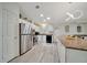 Bright and airy kitchen with stainless steel appliances, island seating, and ample counter space at 926 Saint Andrews Blvd, Lady Lake, FL 32159