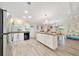 Spacious kitchen featuring an island with seating, stainless steel appliances, and lots of counter space for meal prep at 926 Saint Andrews Blvd, Lady Lake, FL 32159