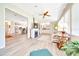 Open-concept living area featuring a fireplace, wet bar, kitchen, and plenty of natural light at 926 Saint Andrews Blvd, Lady Lake, FL 32159