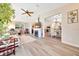 Cozy living room featuring a fireplace and an open dining area at 926 Saint Andrews Blvd, Lady Lake, FL 32159