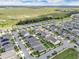Aerial shot of a residential area, highlighting the community's neat landscaping, modern homes, and proximity to green spaces at 9380 La Salle St, Groveland, FL 34736