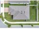 Aerial view of house, showcasing roof, green lawn, sidewalks, and fenced-in backyard at 9380 La Salle St, Groveland, FL 34736