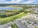 Scenic aerial view showcases the community's proximity to a beautiful lake, lush greenery, and well-maintained homes in a friendly neighborhood at 9380 La Salle St, Groveland, FL 34736