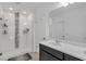 Modern bathroom featuring a glass shower, white tiling, and a dual sink vanity at 9380 La Salle St, Groveland, FL 34736
