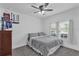 Cozy bedroom with gray carpet, ceiling fan, and window with natural light at 9380 La Salle St, Groveland, FL 34736