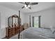 Well-lit bedroom features a four-poster bed, a large dresser with mirror, and a side window at 9380 La Salle St, Groveland, FL 34736