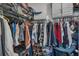 Walk-in closet with ample storage space, featuring hanging racks and shoe shelves filled with clothing and accessories at 9380 La Salle St, Groveland, FL 34736