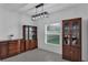 The dining room features a dark wood china cabinet and a modern, linear light fixture above the table at 9380 La Salle St, Groveland, FL 34736