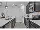 Kitchen with black cabinets, stainless steel appliances, and sleek quartz countertops at 9380 La Salle St, Groveland, FL 34736