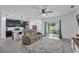 Open-concept living room with a modern kitchen, tile floors, and sliding glass doors at 9380 La Salle St, Groveland, FL 34736
