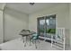 Covered patio with table and chairs, plus a rocking chair, with a view into the backyard at 9380 La Salle St, Groveland, FL 34736