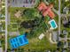 Aerial view of community amenities, including pool, recreation center, tennis courts, and parking at 9790 Se 175Th St, Summerfield, FL 34491