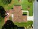 An aerial view of the property shows meticulous landscaping, a charming patio, and a well-maintained roof at 9790 Se 175Th St, Summerfield, FL 34491