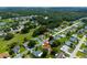 An aerial view captures the residential landscape, showcasing lush greenery and a well-organized street layout at 9790 Se 175Th St, Summerfield, FL 34491