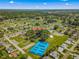 Aerial view showcasing the community: the pool, clubhouse, tennis courts and surrounding neighborhood at 9790 Se 175Th St, Summerfield, FL 34491