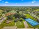 Extensive aerial view highlighting community amenities, including tennis courts, a pond, bocce ball, and clubhouse at 9790 Se 175Th St, Summerfield, FL 34491